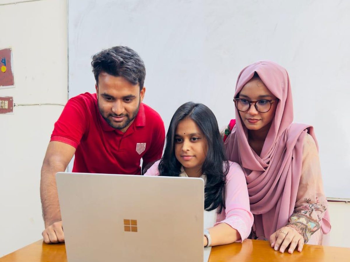 An FRS Global Network counsellor going through a university shortlist with two students in Dhaka